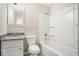 Bathroom with granite countertops, vanity, toilet, and bathtub with white tile surround at 1132 Luther Sw Dr, Mableton, GA 30126