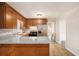 Well-lit kitchen features granite countertops, stainless steel appliances, and wood cabinets at 1132 Luther Sw Dr, Mableton, GA 30126