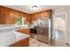 Well-lit kitchen features granite countertops, stainless steel appliances, and wood cabinets at 1132 Luther Sw Dr, Mableton, GA 30126