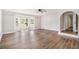Bright living room boasts new floors, a ceiling fan, and a large bay window at 1132 Luther Sw Dr, Mableton, GA 30126