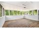 Enclosed porch featuring wood floors, lots of windows, and white walls at 1132 Luther Sw Dr, Mableton, GA 30126