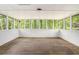 Bright sunroom with wood flooring, and many windows overlooking a green backyard at 1132 Luther Sw Dr, Mableton, GA 30126