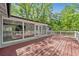 Spacious back porch with wooden floor and a view of the surrounding nature at 3150 Rilman Nw Rd, Atlanta, GA 30327