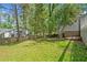 Level grassy backyard, partially fenced with mature trees and shrubs at 3150 Rilman Nw Rd, Atlanta, GA 30327