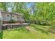 Backyard featuring a brick patio, green lawn, and mature trees at 3150 Rilman Nw Rd, Atlanta, GA 30327