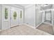 Well-lit foyer featuring tiled flooring, a decorative front door, and access to the main hallway at 3150 Rilman Nw Rd, Atlanta, GA 30327