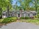 Charming one-story home with a well-manicured lawn, mature trees, and a welcoming front porch at 3150 Rilman Nw Rd, Atlanta, GA 30327