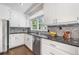 Close up of the Kitchen featuring stone backsplash, stone countertops, and stainless steel appliances at 3150 Rilman Nw Rd, Atlanta, GA 30327