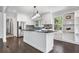 Kitchen with dark stone countertops, island, stainless appliances, white cabinetry, and hardwood flooring at 3150 Rilman Nw Rd, Atlanta, GA 30327