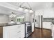 Open kitchen with stainless oven in island overlooking back patio, stainless refrigerator and dark wood floors at 3150 Rilman Nw Rd, Atlanta, GA 30327