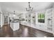 Bright kitchen boasts dark wood floors, white cabinets, stainless appliances and large center island at 3150 Rilman Nw Rd, Atlanta, GA 30327