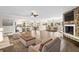 Open-concept living room with hardwood floors, a stone fireplace, and seamless flow to the kitchen at 3150 Rilman Nw Rd, Atlanta, GA 30327