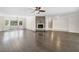 Spacious living room featuring gleaming hardwood floors, a stone fireplace, and ample natural light at 3150 Rilman Nw Rd, Atlanta, GA 30327