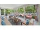 Bright sunroom with large windows offering serene views, neutral furniture, and access to the deck at 3150 Rilman Nw Rd, Atlanta, GA 30327