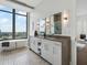 Bright bathroom with double vanity, soaking tub with city views, and herringbone tile floor at 3376 Peachtree Ne Rd # 44B, Atlanta, GA 30326