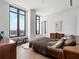 Modern bedroom with large windows featuring city views, wood floors, and unique furnishings at 3376 Peachtree Ne Rd # 44B, Atlanta, GA 30326