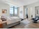 Bedroom featuring city views, hardwood floors, and a sitting area at 3376 Peachtree Ne Rd # 44B, Atlanta, GA 30326