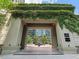 Grand entrance to the building with lush greenery and stone pillars at 3376 Peachtree Ne Rd # 44B, Atlanta, GA 30326