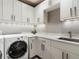 Well-organized laundry room with modern washer, dryer, and ample counter space at 3376 Peachtree Ne Rd # 44B, Atlanta, GA 30326