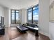 Living room with large windows offering city views, hardwood floors, and contemporary furnishings at 3376 Peachtree Ne Rd # 44B, Atlanta, GA 30326
