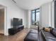 Bright living room with floor-to-ceiling windows, leather seating, and city views at 3376 Peachtree Ne Rd # 44B, Atlanta, GA 30326