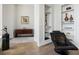 Sitting room featuring hardwood floors, display shelving, and a comfortable chair at 3376 Peachtree Ne Rd # 44B, Atlanta, GA 30326