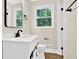 Bright bathroom featuring white vanity with dark fixtures, toilet and natural light at 486 Edward Ct, Marietta, GA 30066