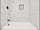 Stylish bathroom featuring a white tiled tub and shower at 486 Edward Ct, Marietta, GA 30066