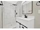 Modern bathroom featuring sleek white vanity and stylish walk-in shower with black shower fixtures at 486 Edward Ct, Marietta, GA 30066