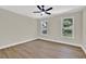 Bright bedroom with hardwood floors, ceiling fan, and two windows at 486 Edward Ct, Marietta, GA 30066