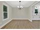 Dining room with modern chandelier, new wood flooring and trim, and large window at 486 Edward Ct, Marietta, GA 30066