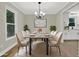 Dining area showcasing modern chandelier, neutral color palette, table setting, and view to the kitchen at 486 Edward Ct, Marietta, GA 30066