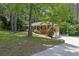 Side view of a well-maintained brick home with an attached garage, set on a lush green lawn with mature trees at 486 Edward Ct, Marietta, GA 30066