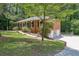Landscaped yard featuring a brick house with attached garage with a long driveway at 486 Edward Ct, Marietta, GA 30066