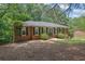 Charming brick ranch-style home featuring a well-maintained lawn and a new roof surrounded by mature trees at 486 Edward Ct, Marietta, GA 30066
