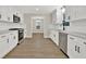 Modern kitchen features white cabinets, stainless steel appliances, and hardwood floors at 486 Edward Ct, Marietta, GA 30066