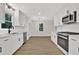Modern kitchen featuring white cabinets, stainless steel appliances, subway tile backsplash and stone countertops at 486 Edward Ct, Marietta, GA 30066