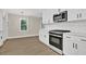 Well-lit kitchen featuring white cabinets, subway tile backsplash, and stainless steel appliances at 486 Edward Ct, Marietta, GA 30066