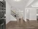 Inviting entryway with hardwood floors, showcasing an open floor plan leading to the staircase and the living room at 76 Parkview Dr, Dallas, GA 30157