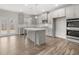 Well-lit kitchen with stainless steel appliances, a center island, and a view to the backyard at 76 Parkview Dr, Dallas, GA 30157