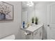 Neutrally decorated bathroom featuring modern vanity, sleek hardware, framed mirror, and decorative greenery at 8609 Lakeview, Jonesboro, GA 30238
