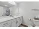 Well-lit bathroom with a quartz countertop vanity, toilet, and shower with a curtain, providing essential amenities at 8609 Lakeview, Jonesboro, GA 30238