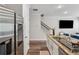 Updated kitchen with stainless steel appliances, granite countertops, and a view of the staircase at 8609 Lakeview, Jonesboro, GA 30238