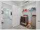 Convenient laundry room with modern washer and dryer; bedroom visible through door at 8609 Lakeview, Jonesboro, GA 30238