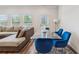 Stylish living room boasts a glass table with blue chairs adjacent to a comfy sectional sofa at 8609 Lakeview, Jonesboro, GA 30238