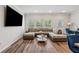 Open-concept living room features a comfortable sectional, modern decor, and plenty of natural light at 8609 Lakeview, Jonesboro, GA 30238