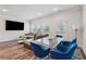 Bright, open living area featuring a modern sectional sofa, glass dining table and television at 8609 Lakeview, Jonesboro, GA 30238