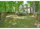 Expansive backyard with lush green lawn, mature trees, and a white two-story home at 120 Stanmore Ct, Roswell, GA 30075