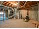 Unfinished basement with exposed wooden ceiling and concrete walls at 120 Stanmore Ct, Roswell, GA 30075