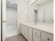Bathroom featuring a long vanity, mirror, bathtub and carpeted floors at 120 Stanmore Ct, Roswell, GA 30075